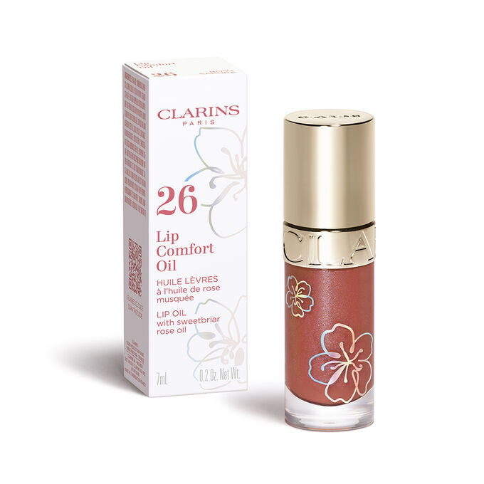 Packshot of the Clarins Lip Comfort Oil in the shade Rosy Sakura from the Fairy Blossoms range and its secondary packaging.