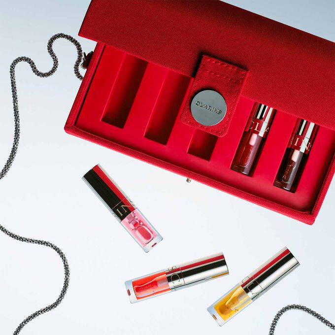 Close-up of the interior of the pouch, showcasing the different compartments holding the Lip Oils.