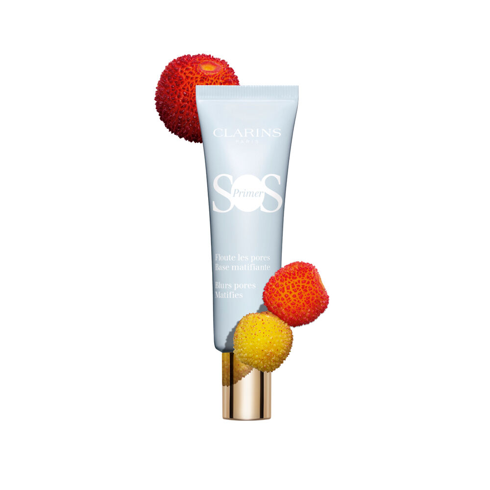 Tube of SOS Primer Mattifying by Clarins, which blurs pores and reduces shine, surrounded by strawberries and other fruits.