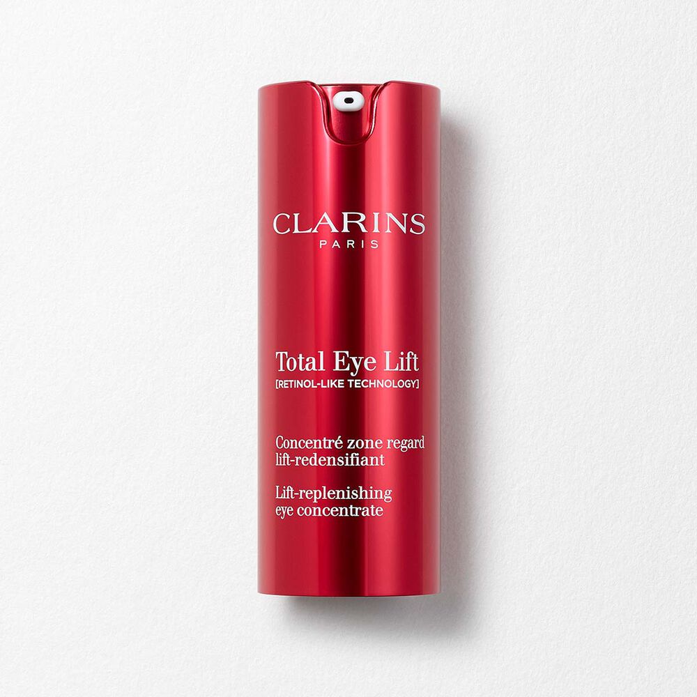 Packshot of Clarins Total Eye Lift anti-aging eye cream with harungana leaves on a dark red background.