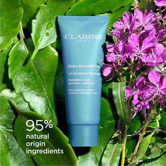 Packshot of Clarins Hydra-Essentiel Matte Gel among Alpine willowherb, highlighting its 92% natural origin ingredients.