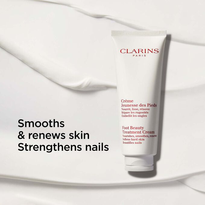 Packshot of Clarins Foot Beauty Treatment Cream on a creamy-textured background with text emphasising its nourishing benefits.