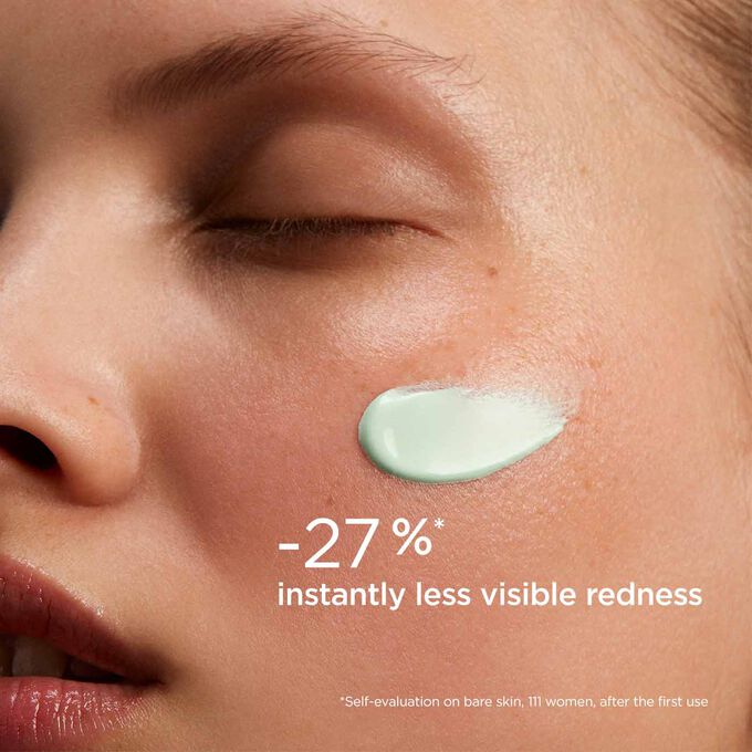 Woman wearing SOS Primer Green by Clarins to illustrate that it reduces redness by 27%.
