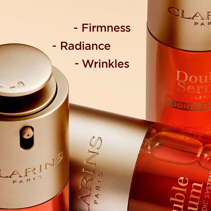 Close-up of Clarins Double Serum Light Texture bottles, highlighting enhanced firmness, radiance, and reduced wrinkles.