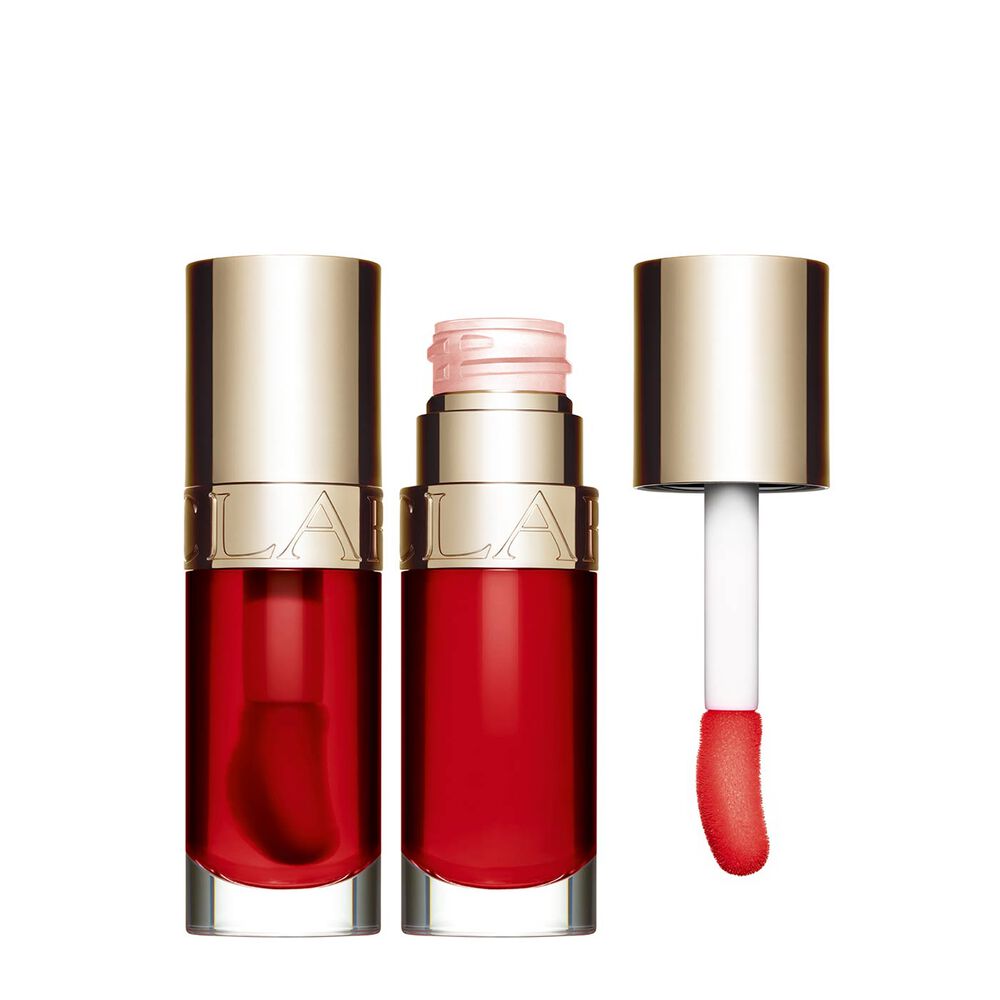 Packshot of Clarins Lip Comfort Oil Strawberry, placed next to a sweetbriar rose on a light pink background.