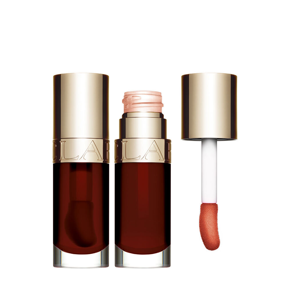 Packshot of Clarins Lip Comfort Oil Chocolate, placed next to a sweetbriar rose on a light pink background.