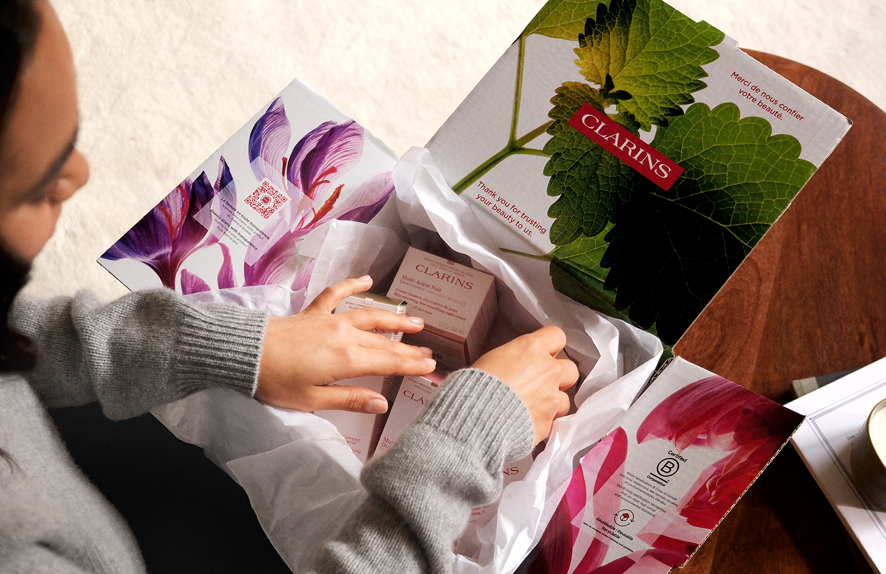 Woman opening a parcel at home in comfy mode